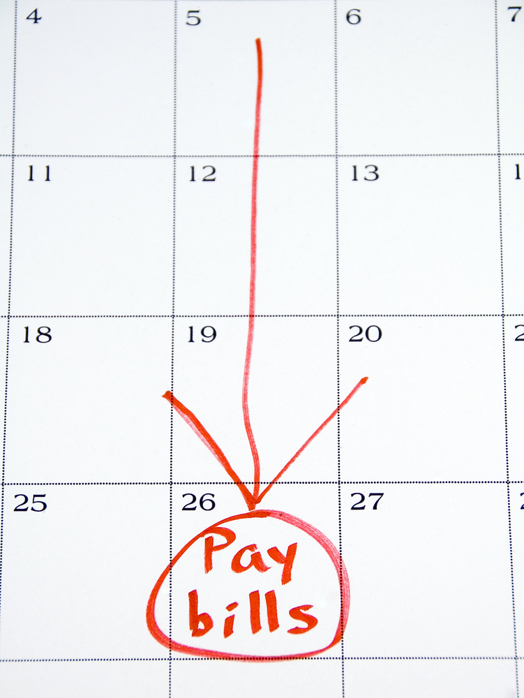 Pay bills circled in red on white monthly calendar